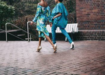 two women in teal romper pants