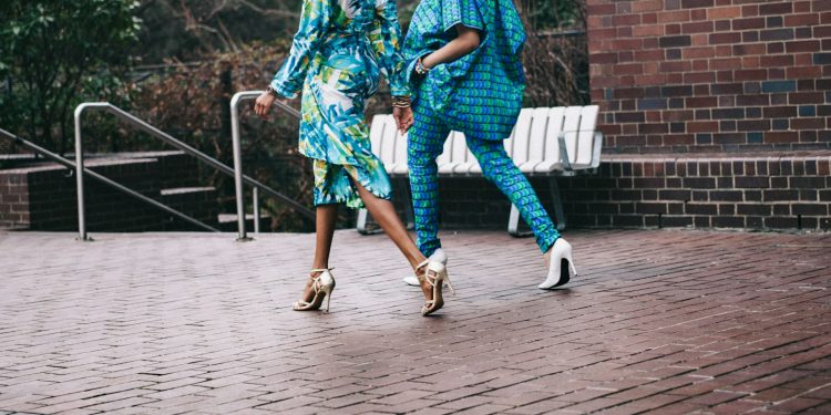 two women in teal romper pants