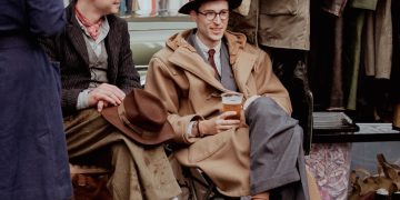 a man sitting in a chair next to a woman