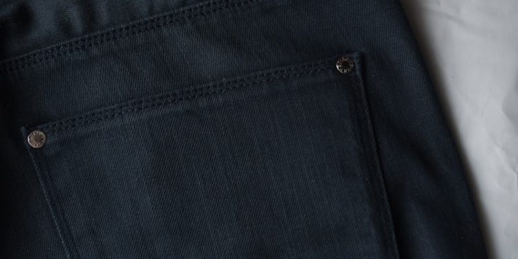 black denim bottoms on white textile