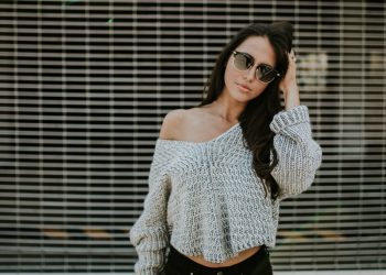 woman holding her head while standing