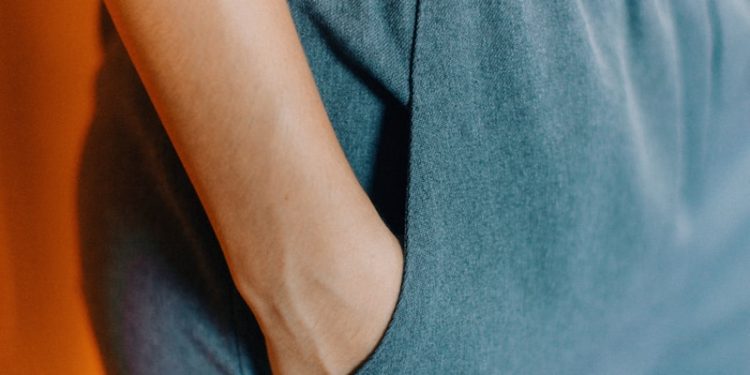 closeup photo of person hiding his right hand in his pocket