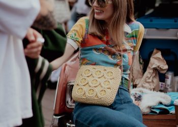 a woman sitting on the back of a car