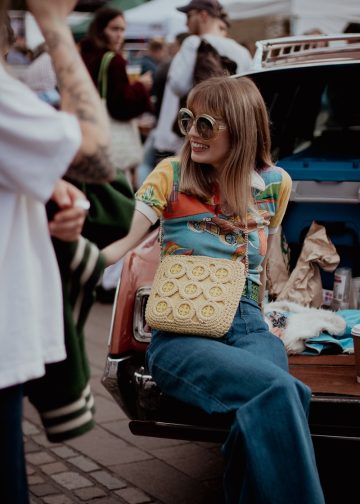 a woman sitting on the back of a car