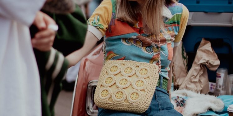 a woman sitting on the back of a car