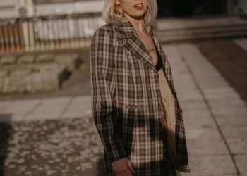 woman wearing brown and white plaid coat during daytime