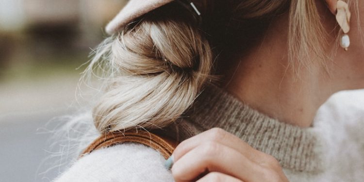 woman wearing hat and carrying bag